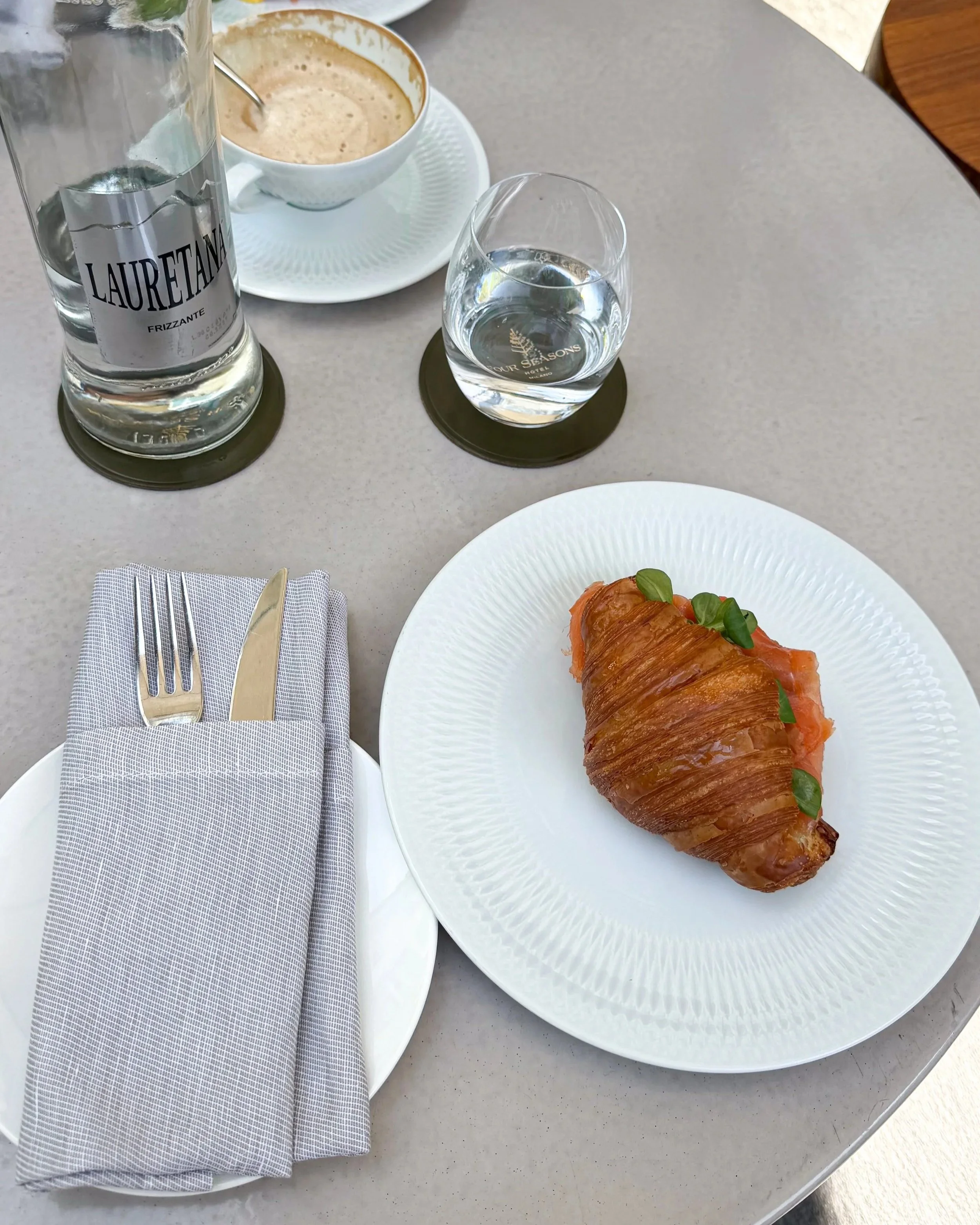 Croissant with salmon and avocado served with coffee and water at Four Seasons Hotel Milano.