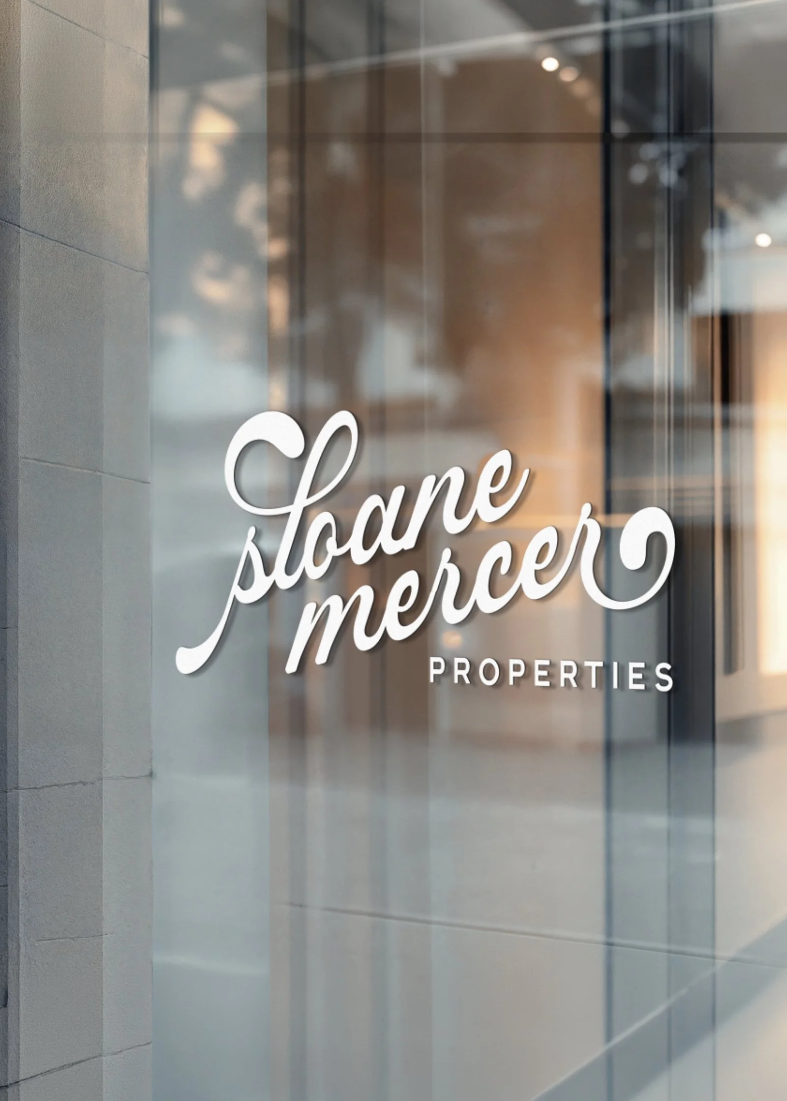 Glass window with white cursive text that reads 'store pormer', part of the word 'properties' visible at the bottom.