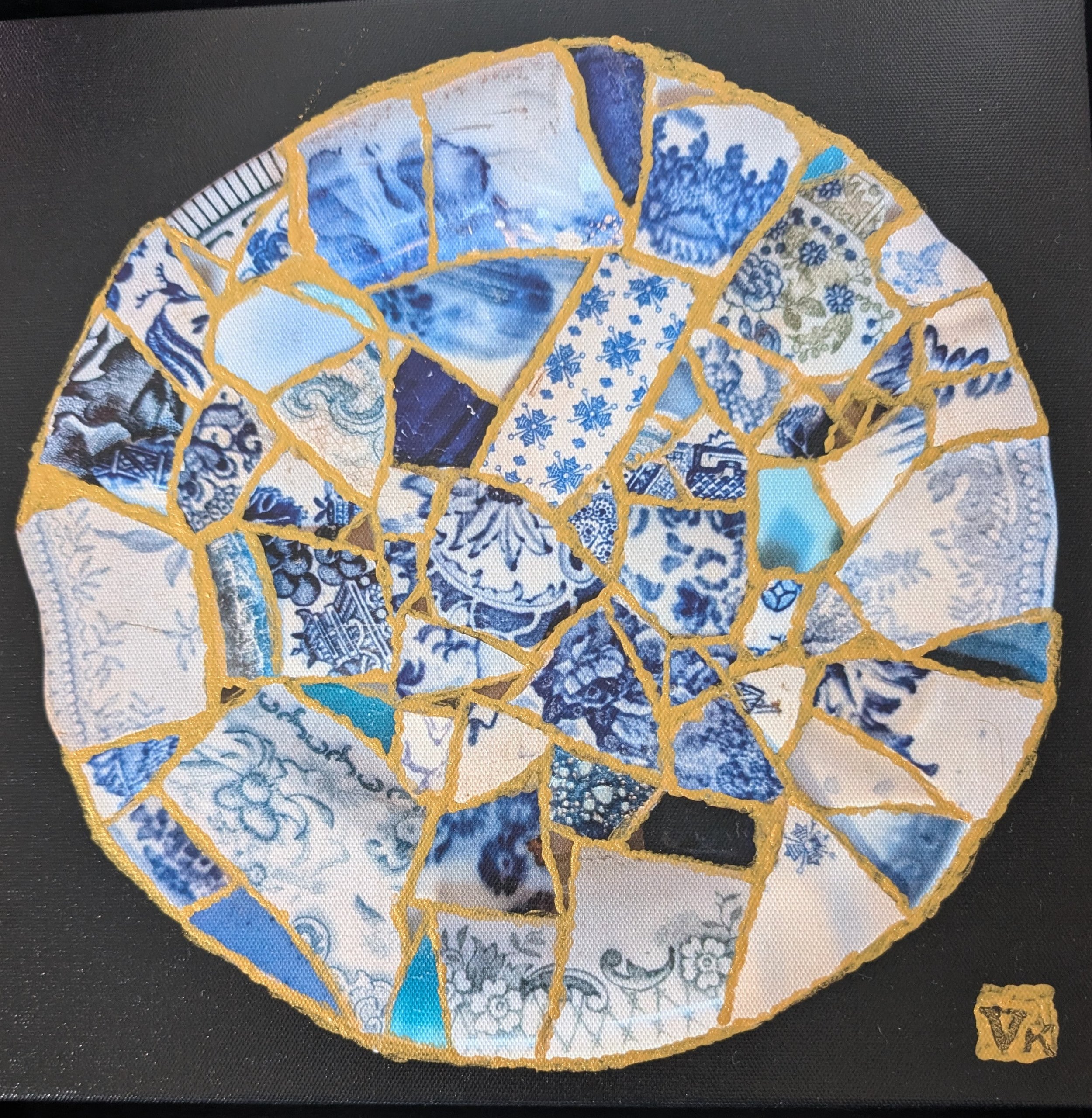 A plate made of broken blue pieces with gold holding it together
