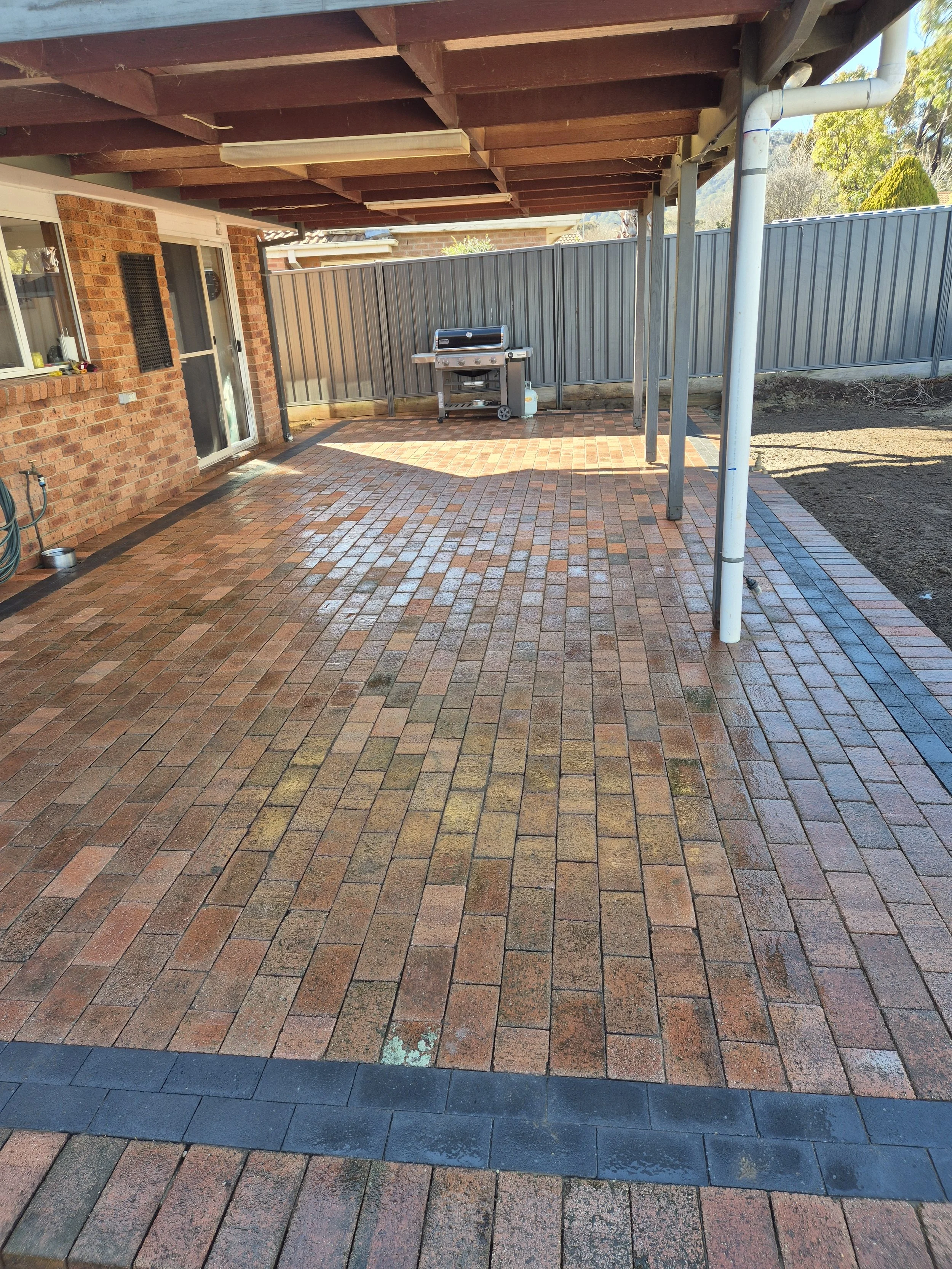 Custom paving project with reused pavers and charcoal border in Conder ACT by Alford Concreting