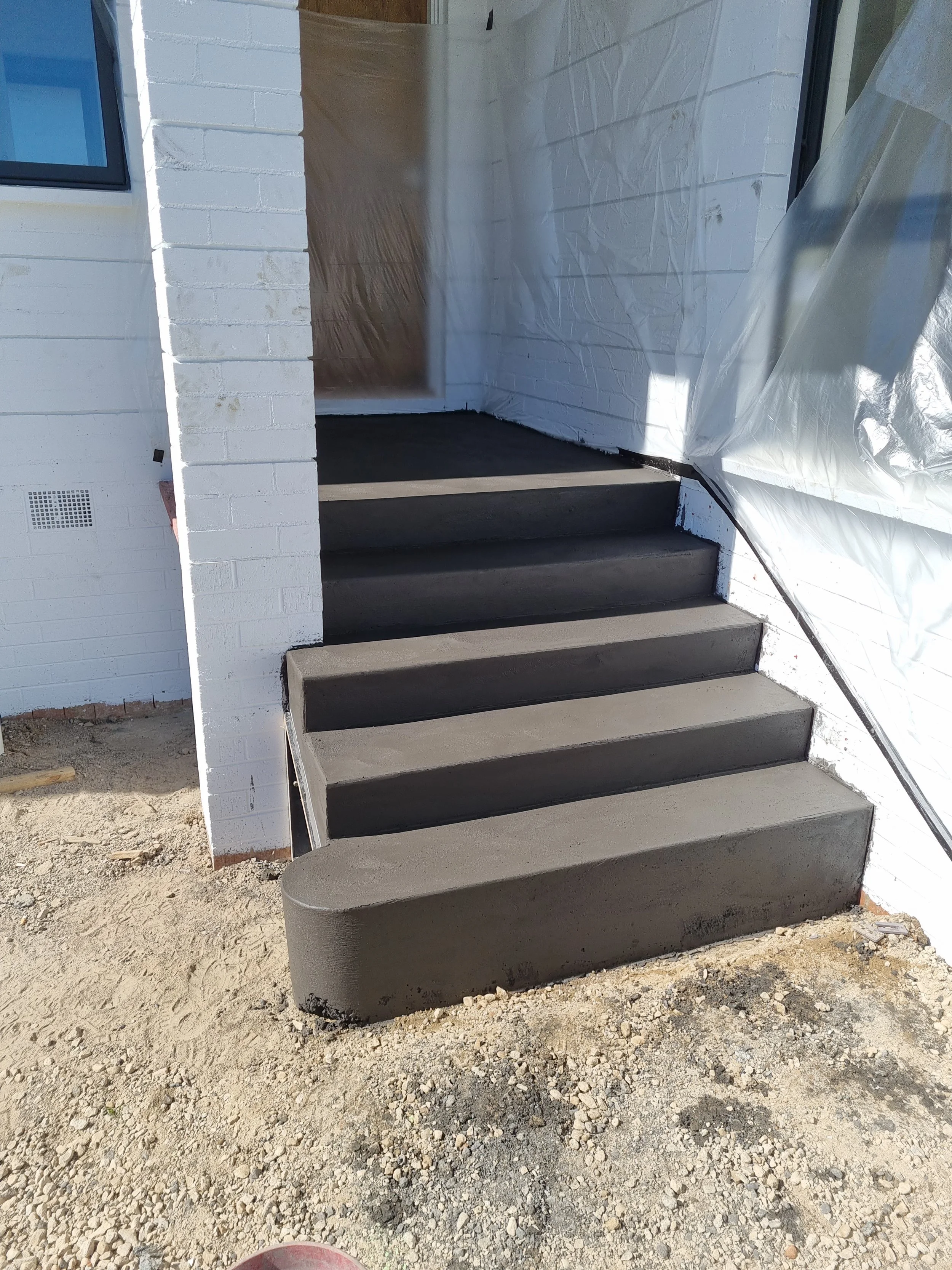 Charcoal concrete steps in Weston ACT by Alford Concreting
