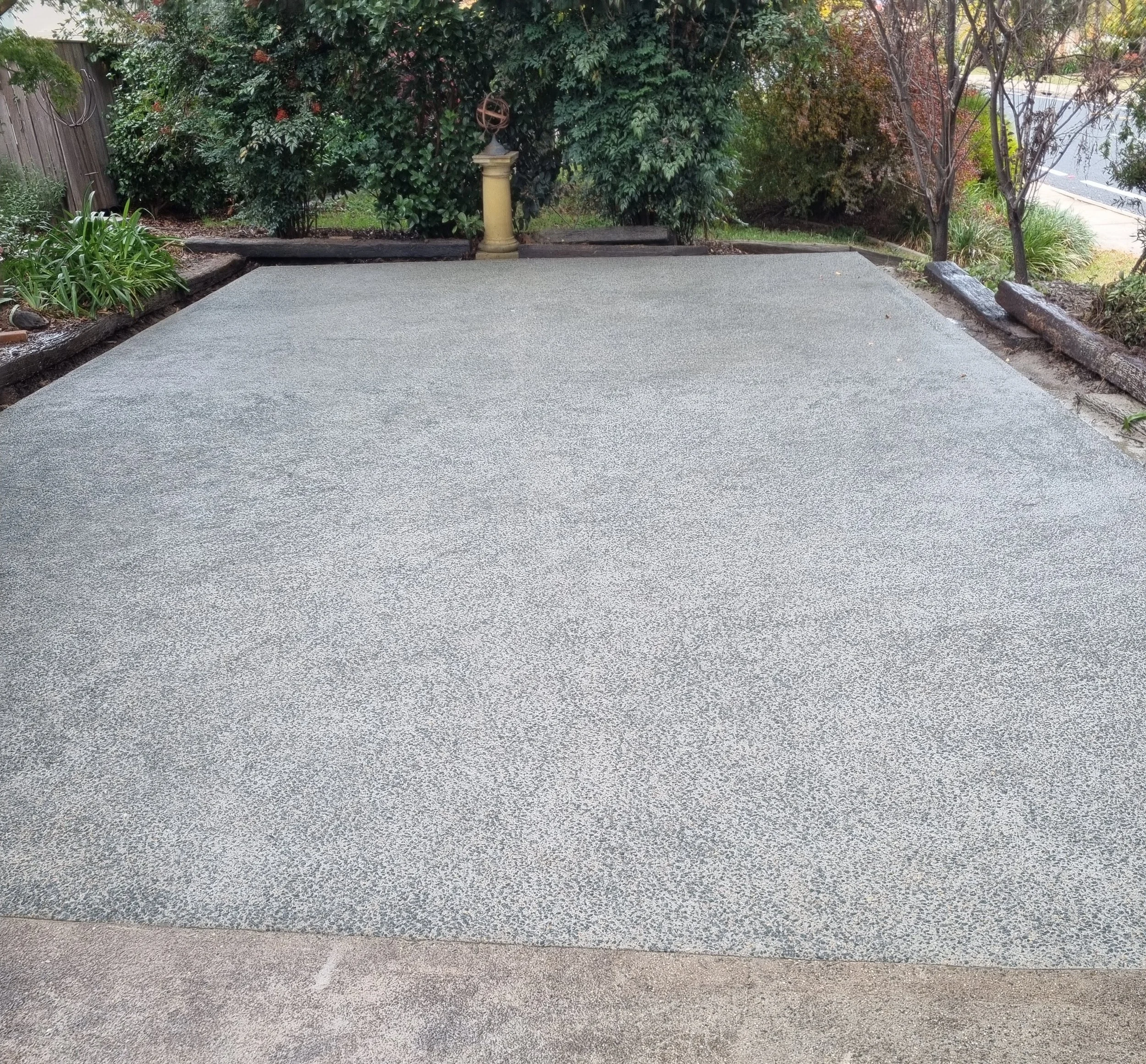 Aged exposed aggregate concrete caravan parking area in Oxley ACT by Alford Concreting