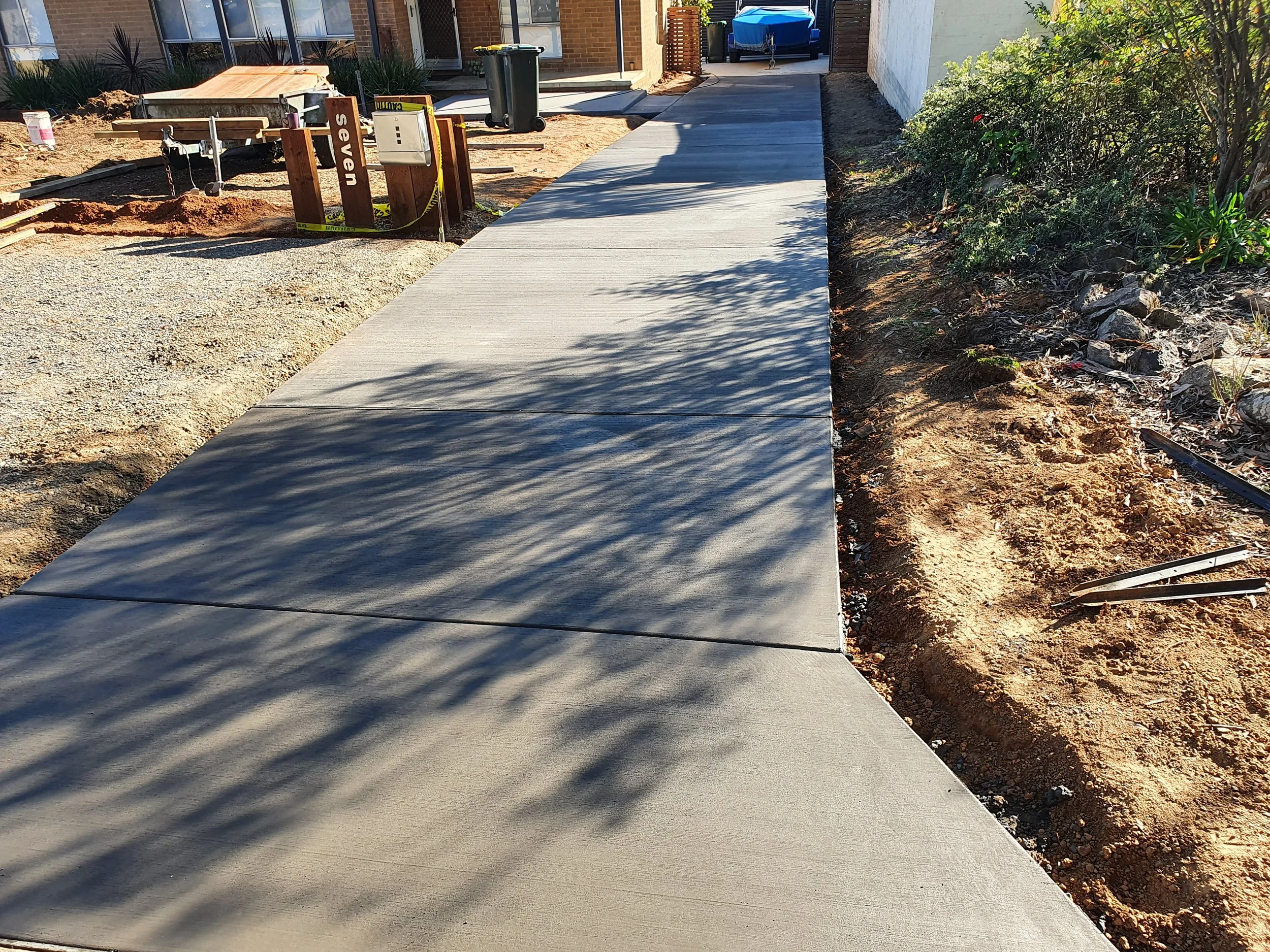 Charcoal concrete driveway in Scullin ACT by Alford Concreting