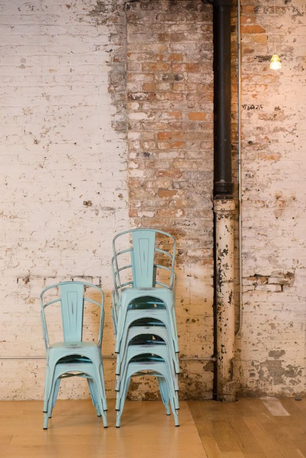 image of the joinery blue chairs, wedding venue with distressed white brick wall