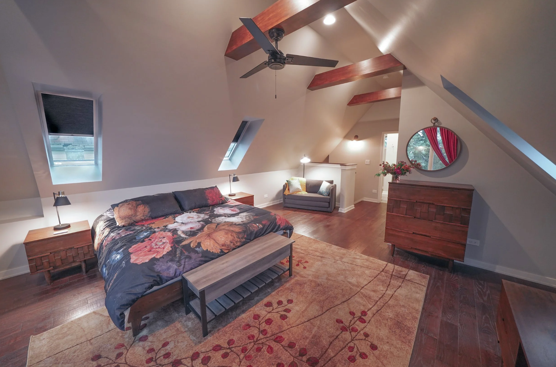 image of a king bedroom with skylights and natural wooden beams, at the mill house next to the joinery wedding venue