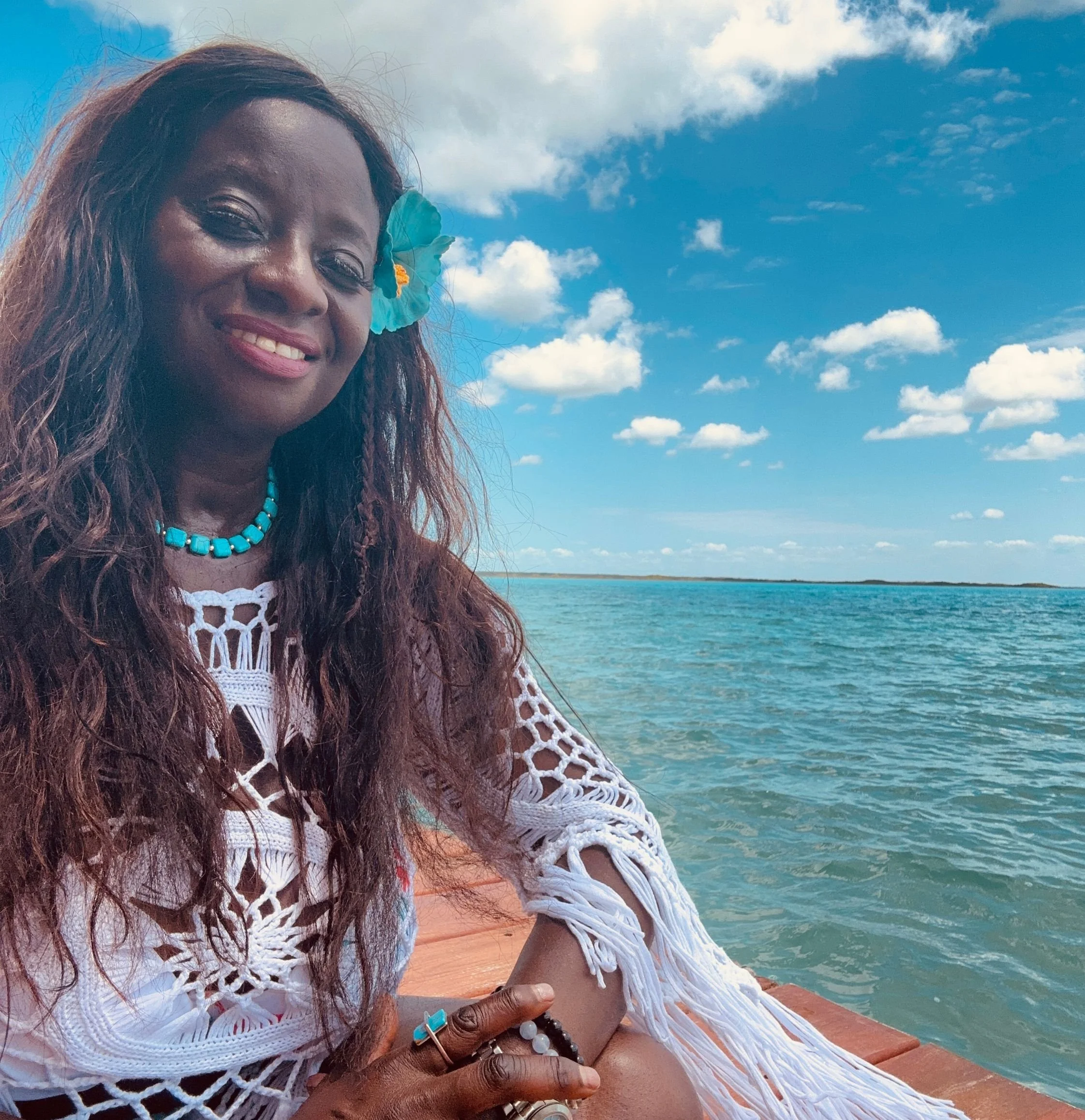 beautiful black woman smiling at the lagoon