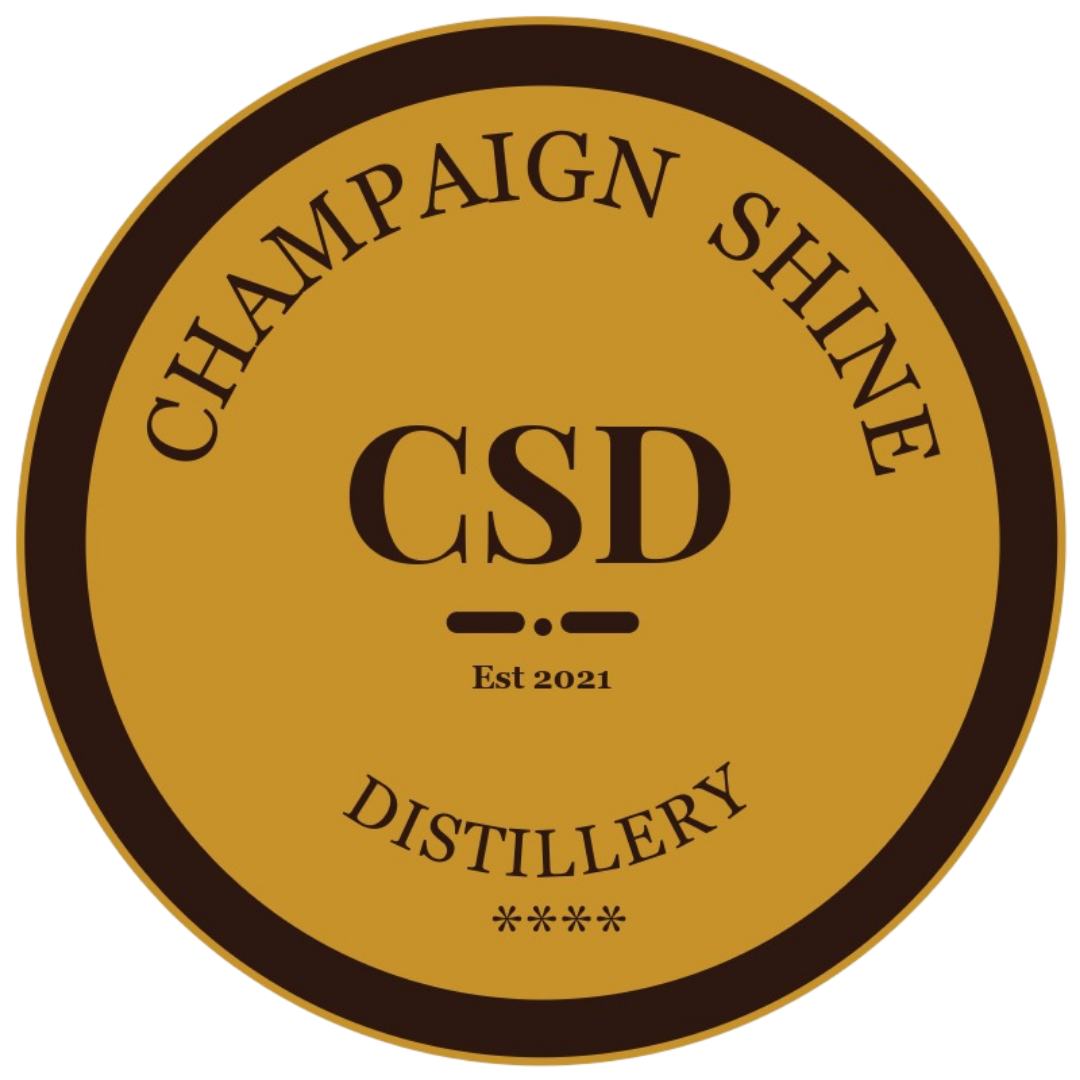A circular logo for Champaign Shave Distillery with a gold background, black text, and border, featuring the letters 'CSD' in the center, established in 2021.