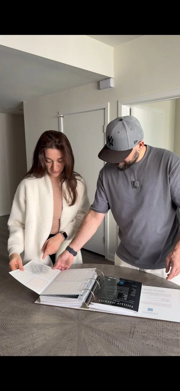 Agai Wallpaper installer and customer reviewing wallpaper samples during consultation in Los Angeles