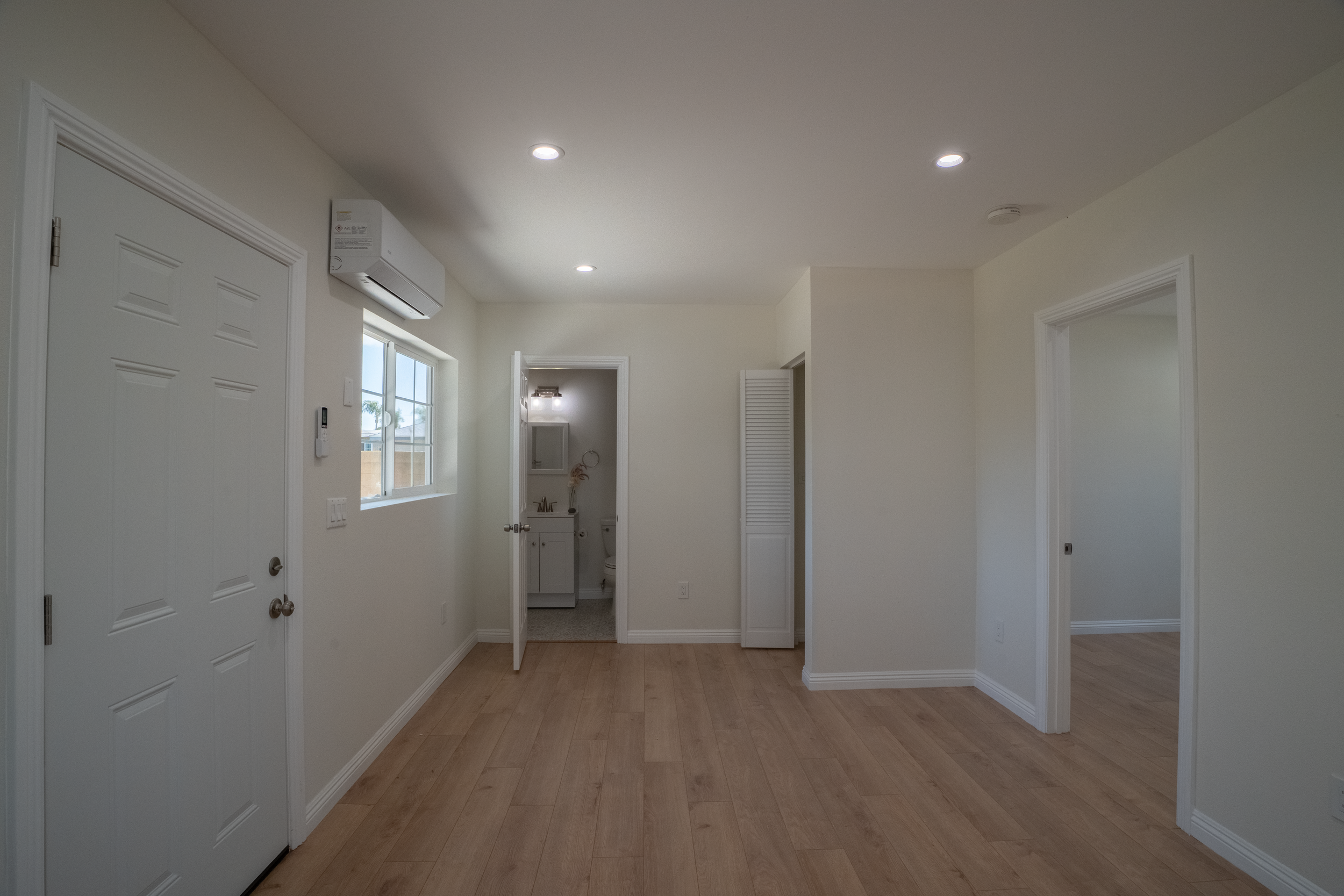 Small living areas with side closet large enough for compact laundry and bathroom at the end of the room.