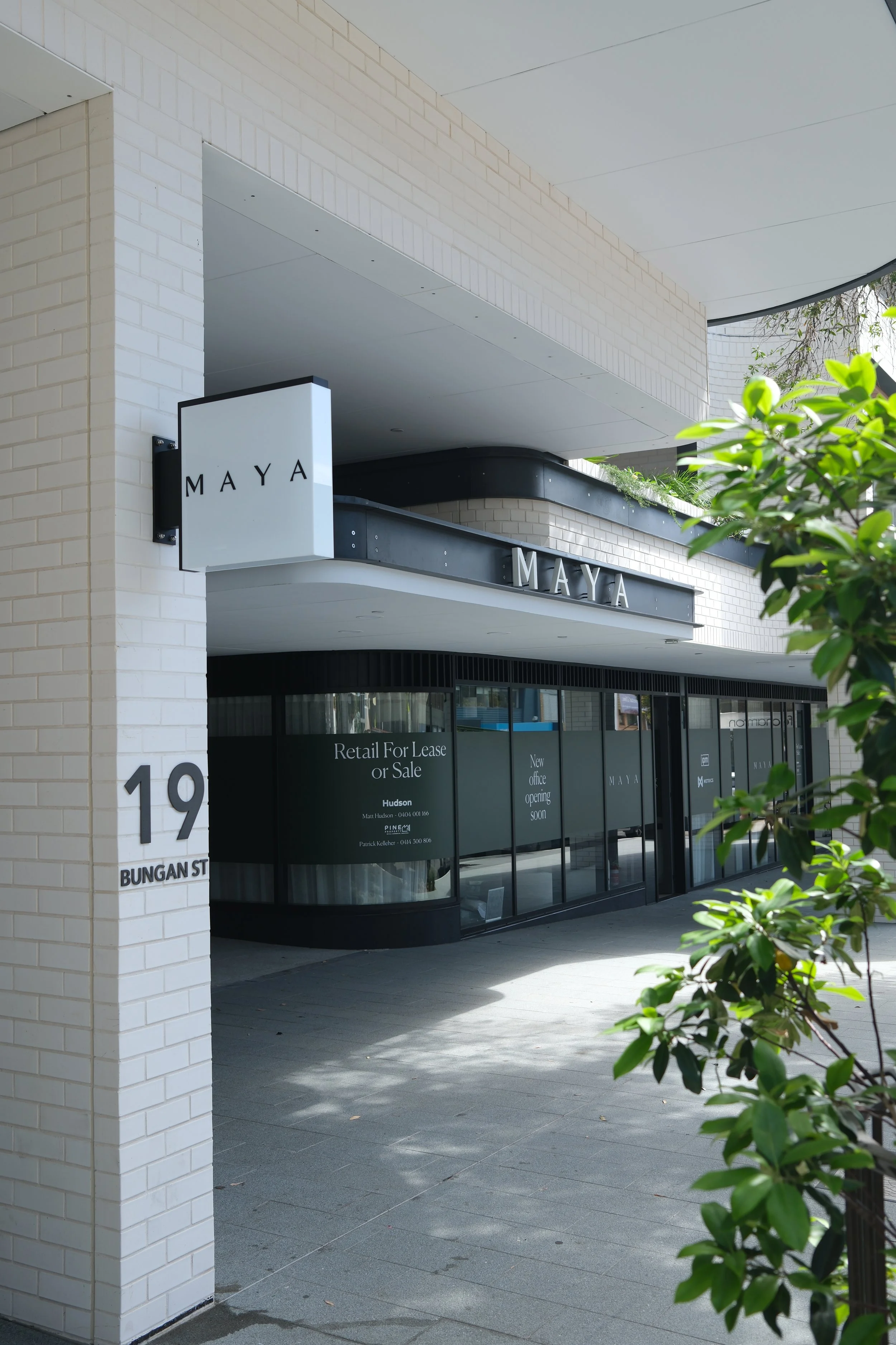 Illuminated wayfinding and statutory signage at Maya Mona Vale, 33-apartment mixed-use development, Northern Beaches