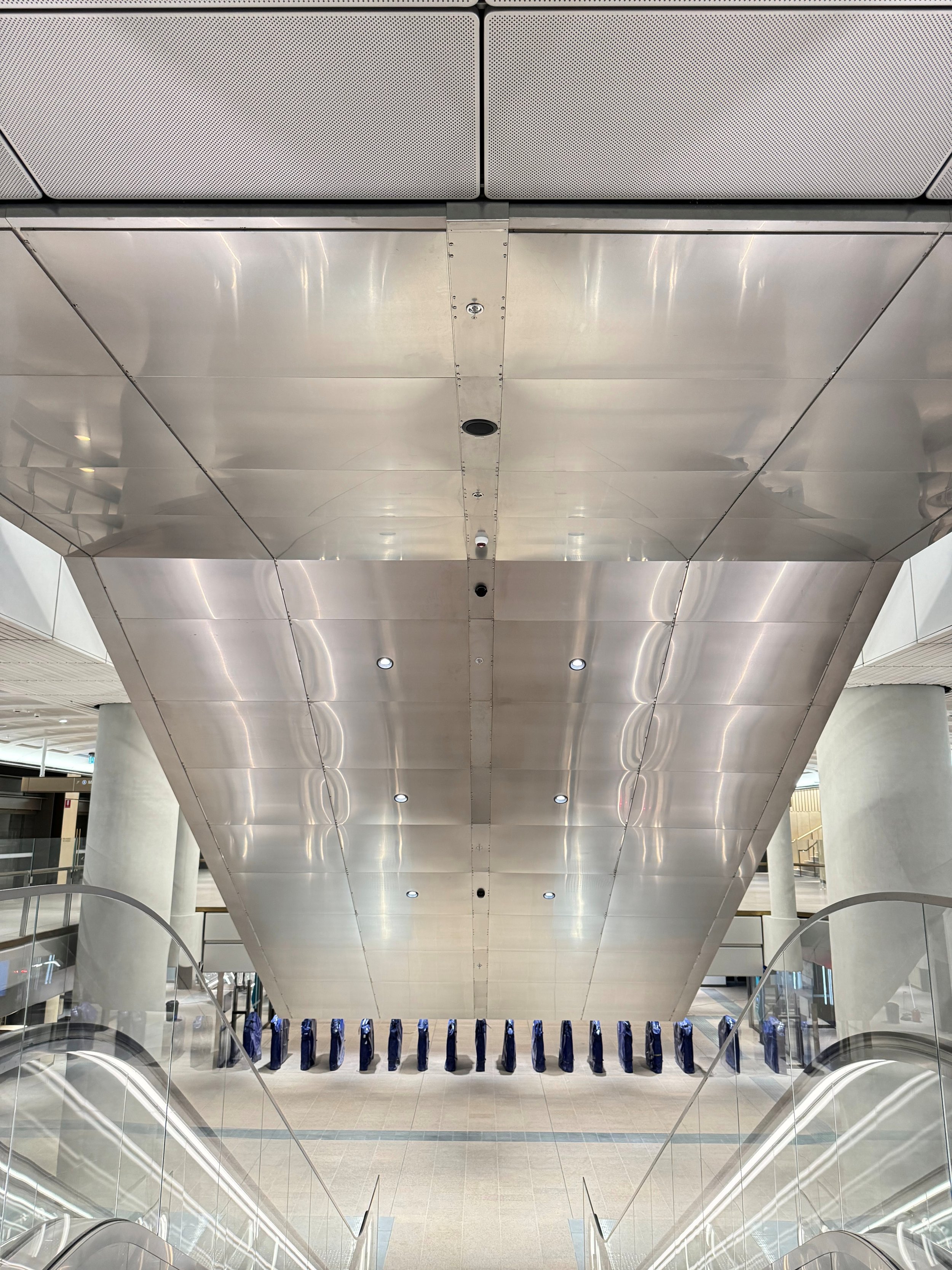 Perforated stainless steel soffit panels and in situ welded metalwork at Sydney Metro City stations, delivered for TKE