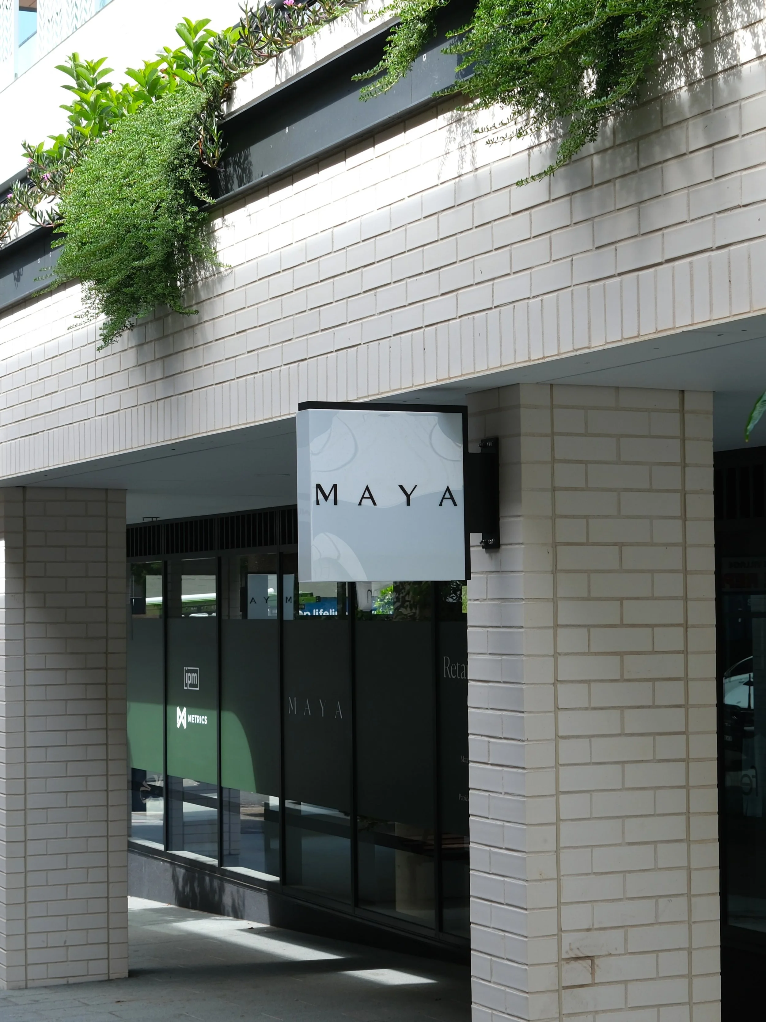 Illuminated facade and entry signage at Maya mixed-use development, Northern Beaches Sydney