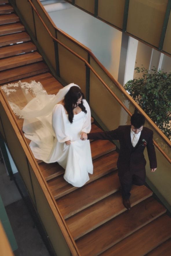 bride and groom walking down the stairs at their reception  in charlotte north carolina