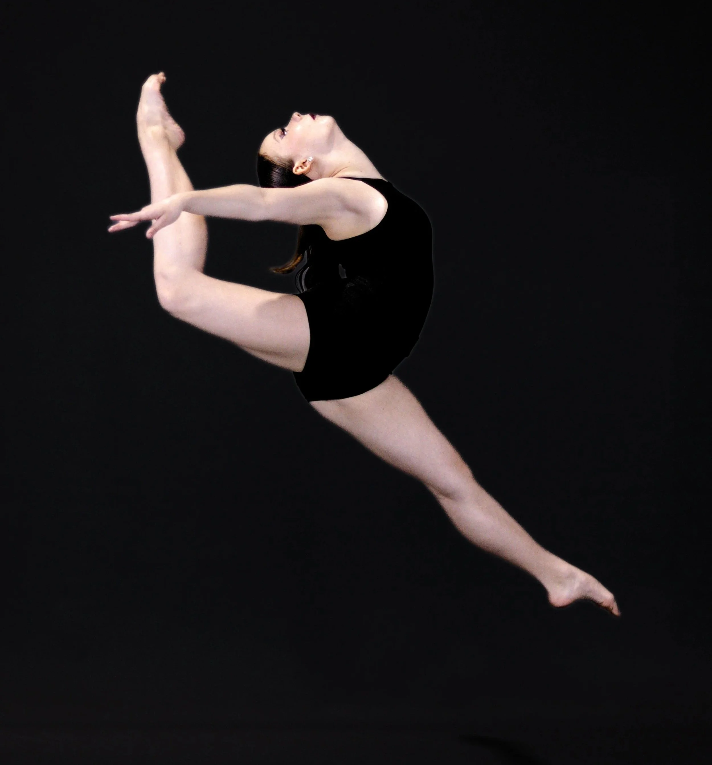 A dancer in black leotard performing a contorted dance pose against a black background.