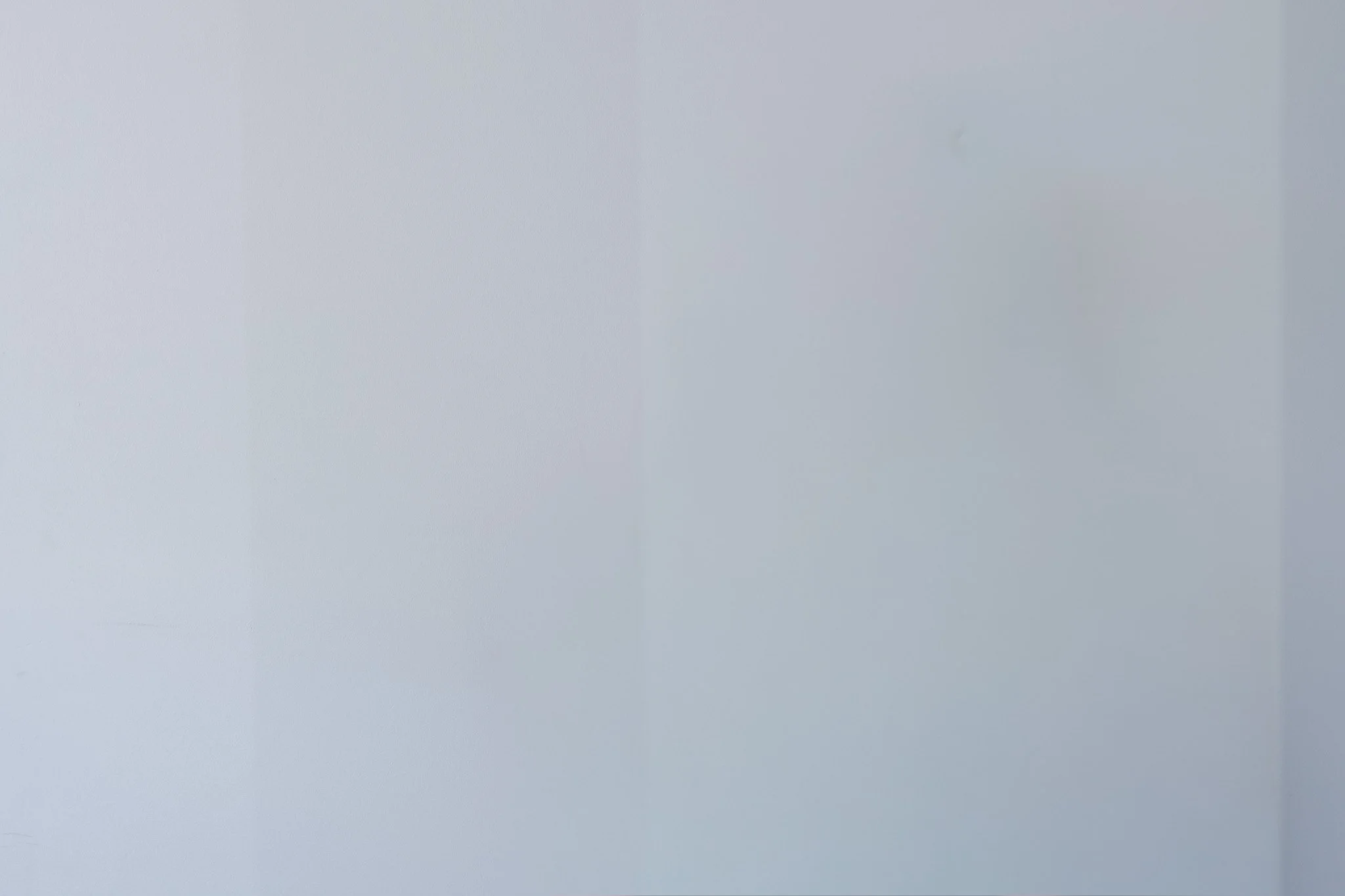 Bunbury Physio - A light gray smooth wall with a faint vertical line on the right side.
