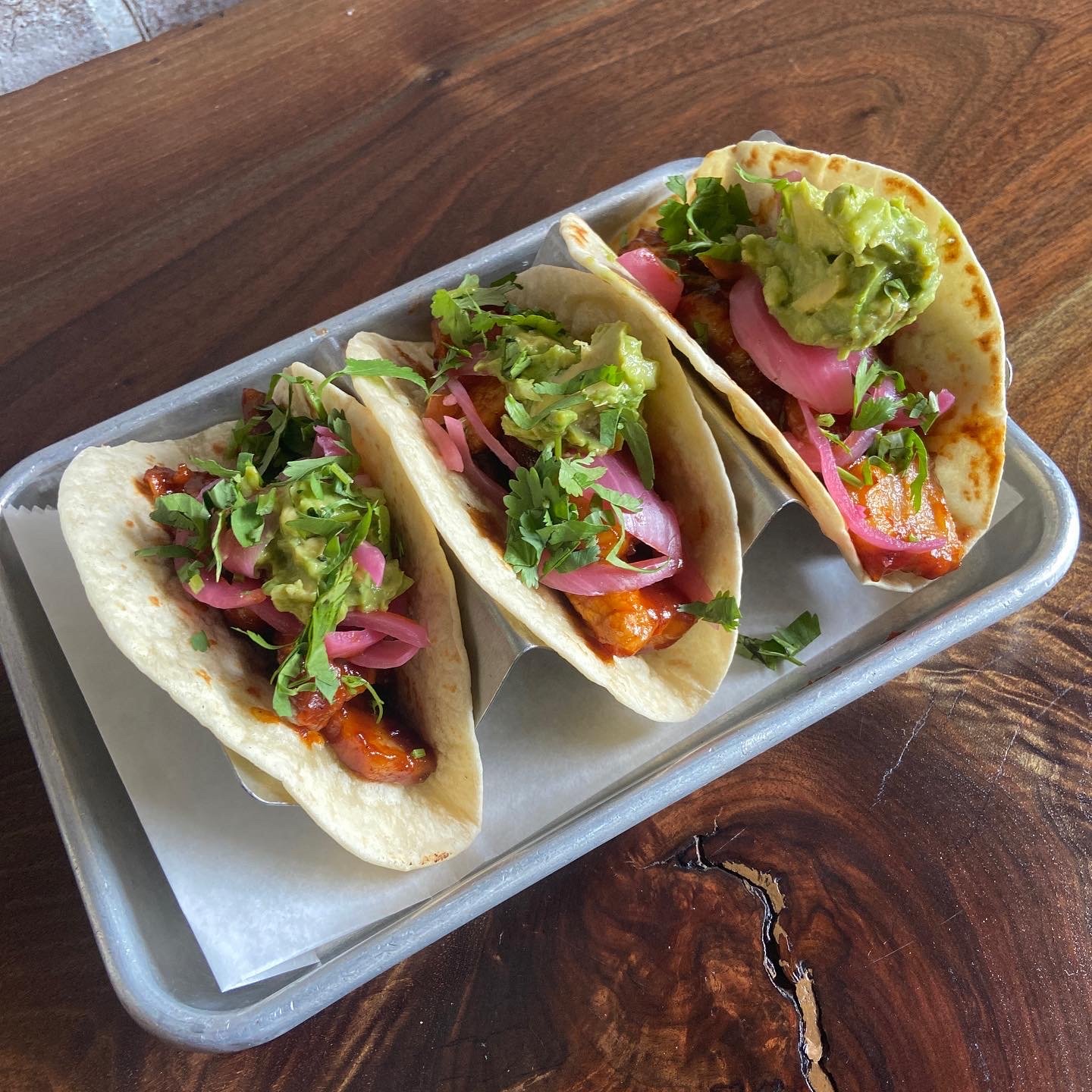 three soft tacos on a tray