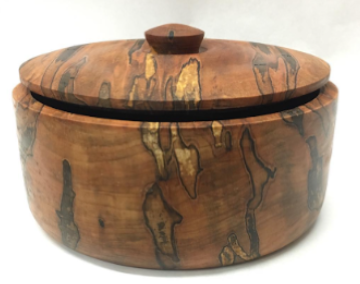A round wooden container with a lid, featuring a natural wood grain pattern.