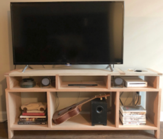 Flat-screen TV on a wooden entertainment center with books, DVDs, a guitar, and audio equipment.