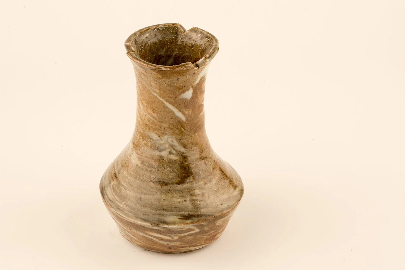 A ceramic vase with a swirling brown and beige glaze, featuring a narrow neck and wide base, placed on a plain light-colored background.