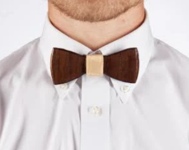 Close-up of a man wearing a white dress shirt and a dark wooden bow tie with a light-colored center clasp.
