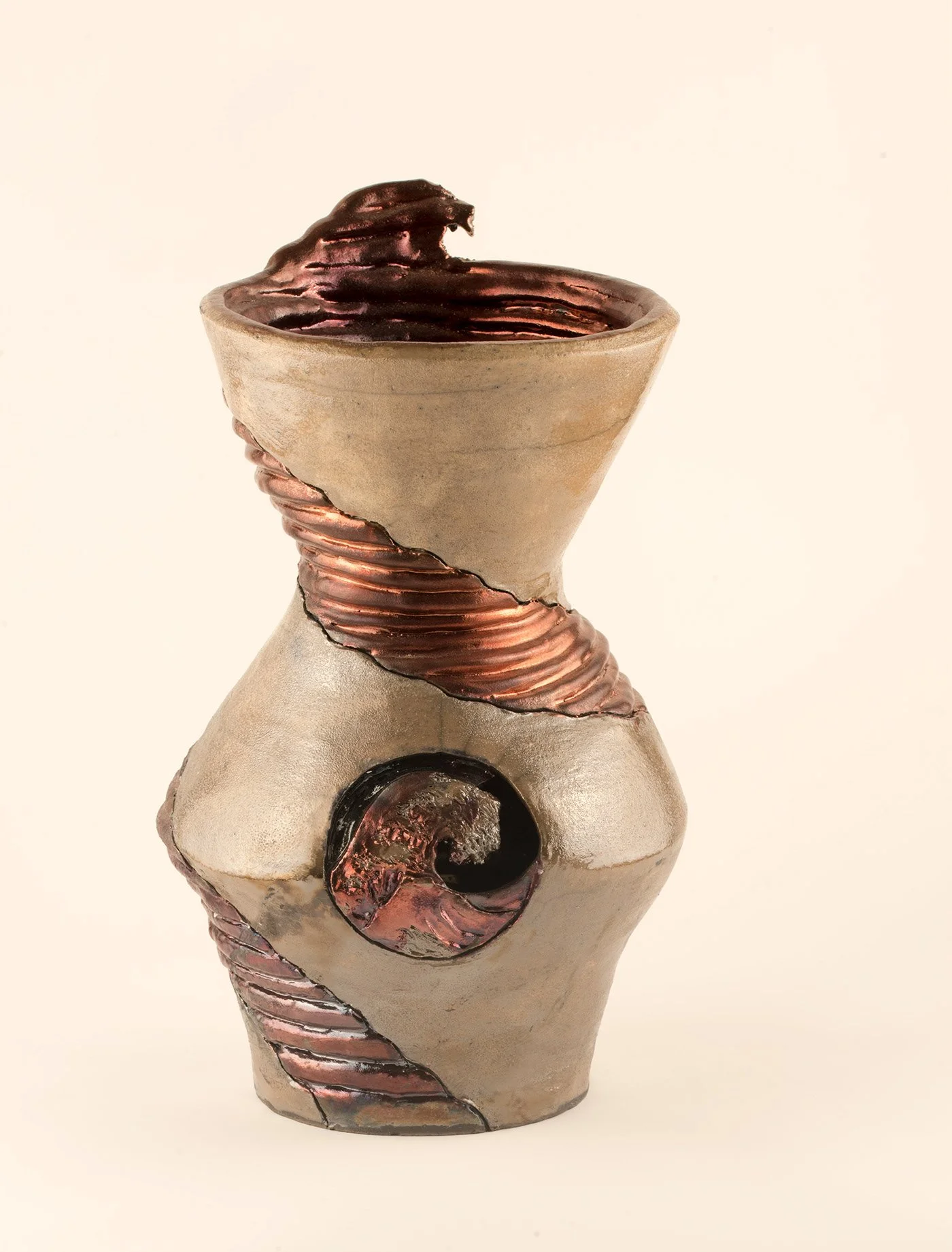 A ceramic sculpture in an abstract form featuring copper-colored and beige textured surfaces, with curved and spiral elements, and a round opening near the bottom.