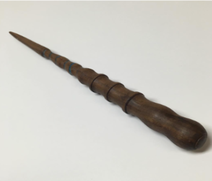 A wooden recording stylus with a carved handle and metal tip, used for inscribing on wax cylinders.