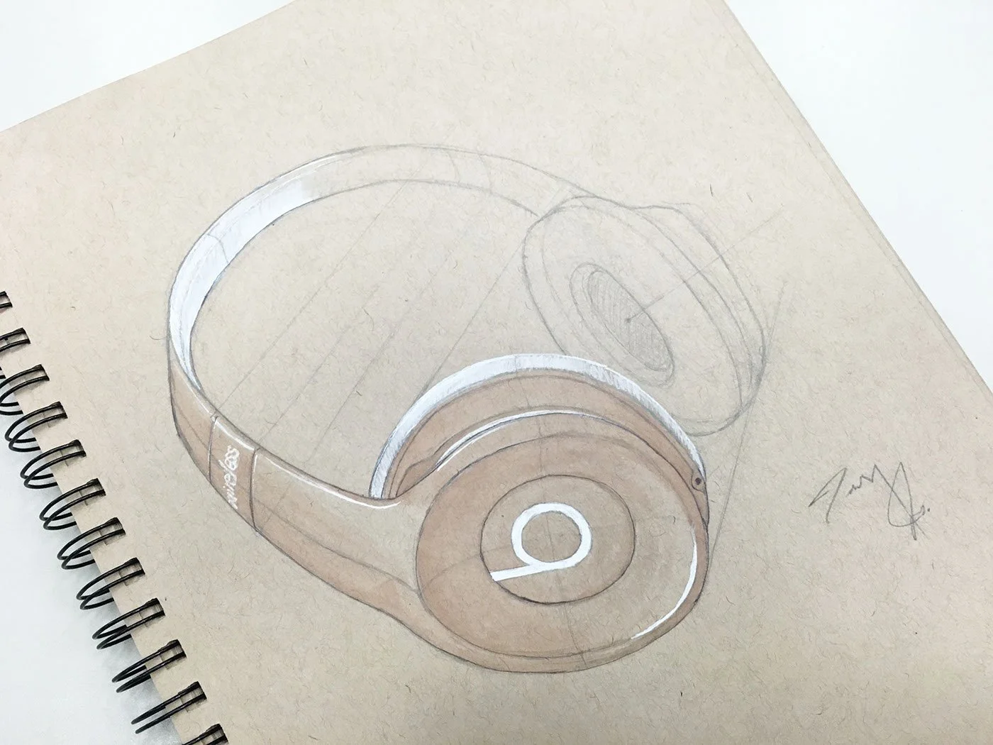Sketch of a pair of over-ear headphones on beige sketchpad.