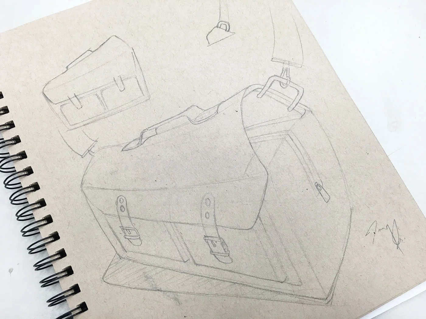 Pencil sketch of a suitcase and shopping bag on a textured paper background.