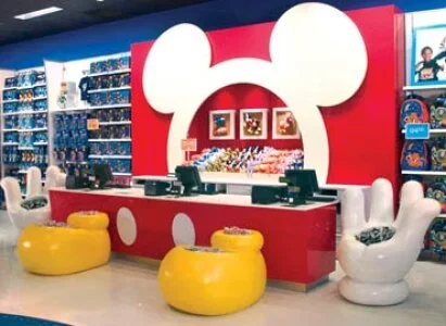 Disney store mouse ears graphic on red wall, in retail space