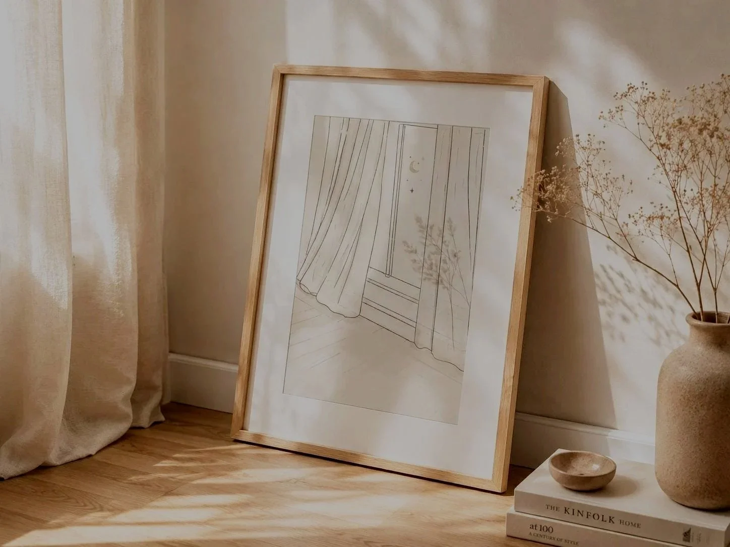 Neutral minimalist corner in a home with  light flowing in, flowing linen curtains and a large digital print from Serein House displaying a quiet window with curtains blowing open at night.