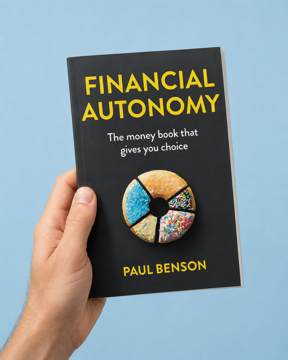 Hand holding Financial Autonomy book by Paul Benson