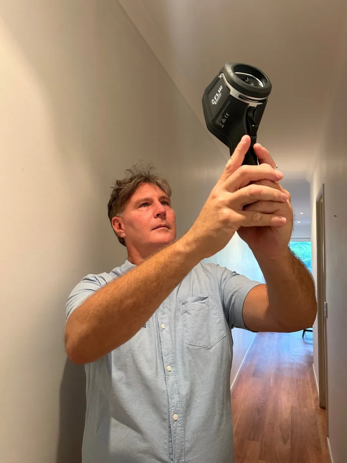 Shane Macfarlane conducting a building inspection using thermal imaging equipment.