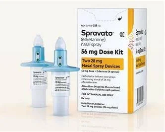 Box of Spravato nasal spray kit and two nasal spray devices, with a bottle of nasal spray in front.