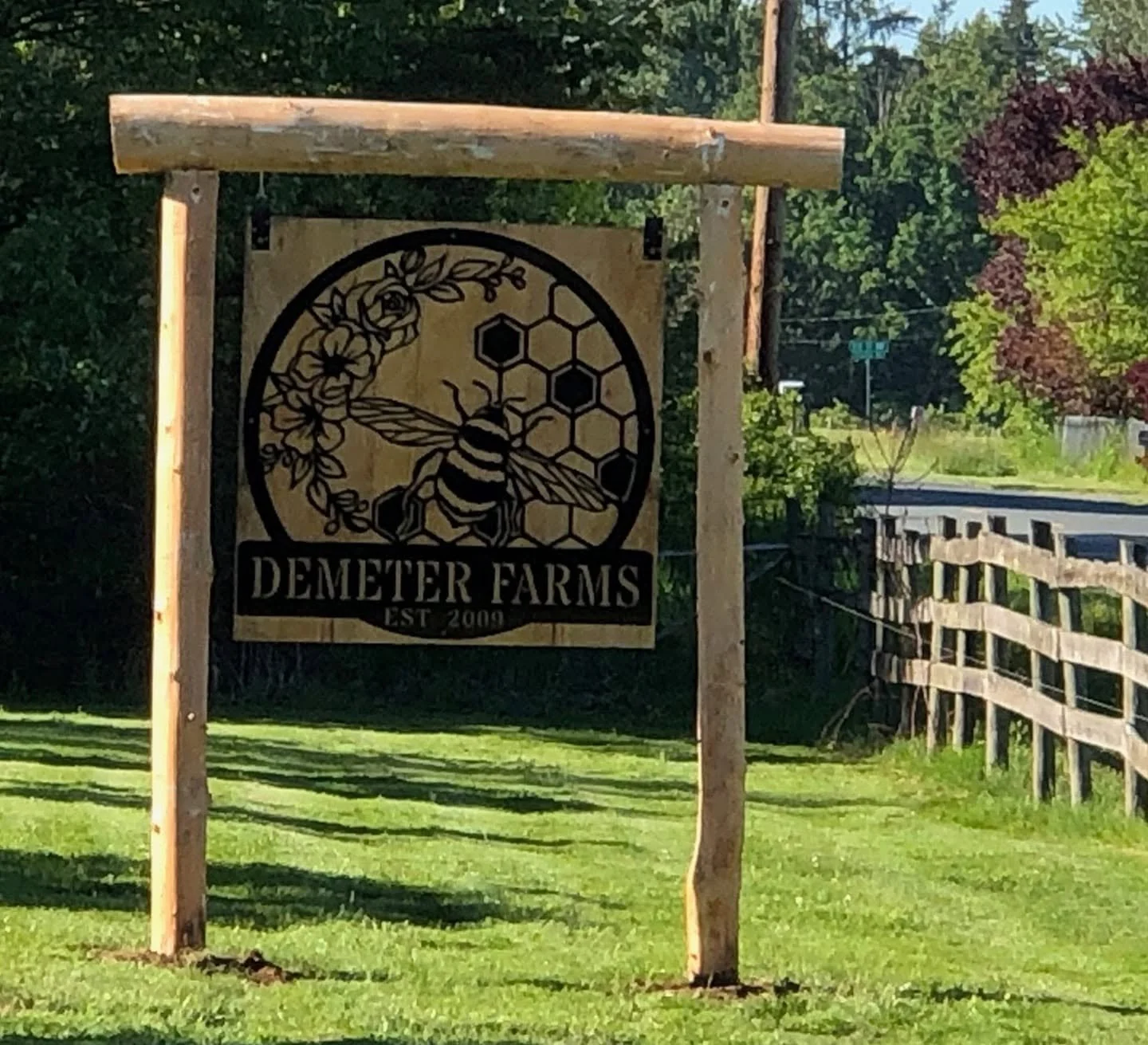 Bespoke CNC-cut metal farm sign with honeybee and honeycomb design for Demeter Farms.