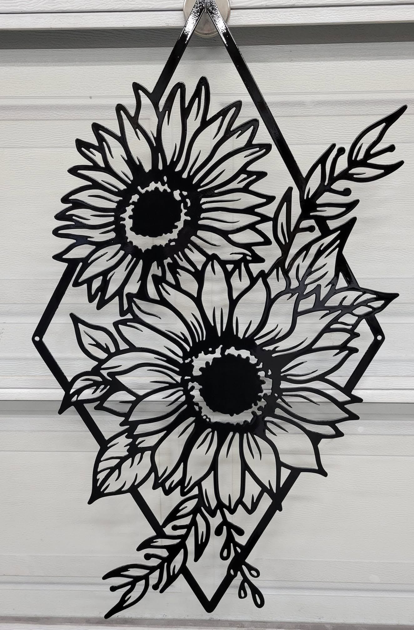 Bespoke CNC-cut metal sunflower wall art with a modern black powder-coated aesthetic.
