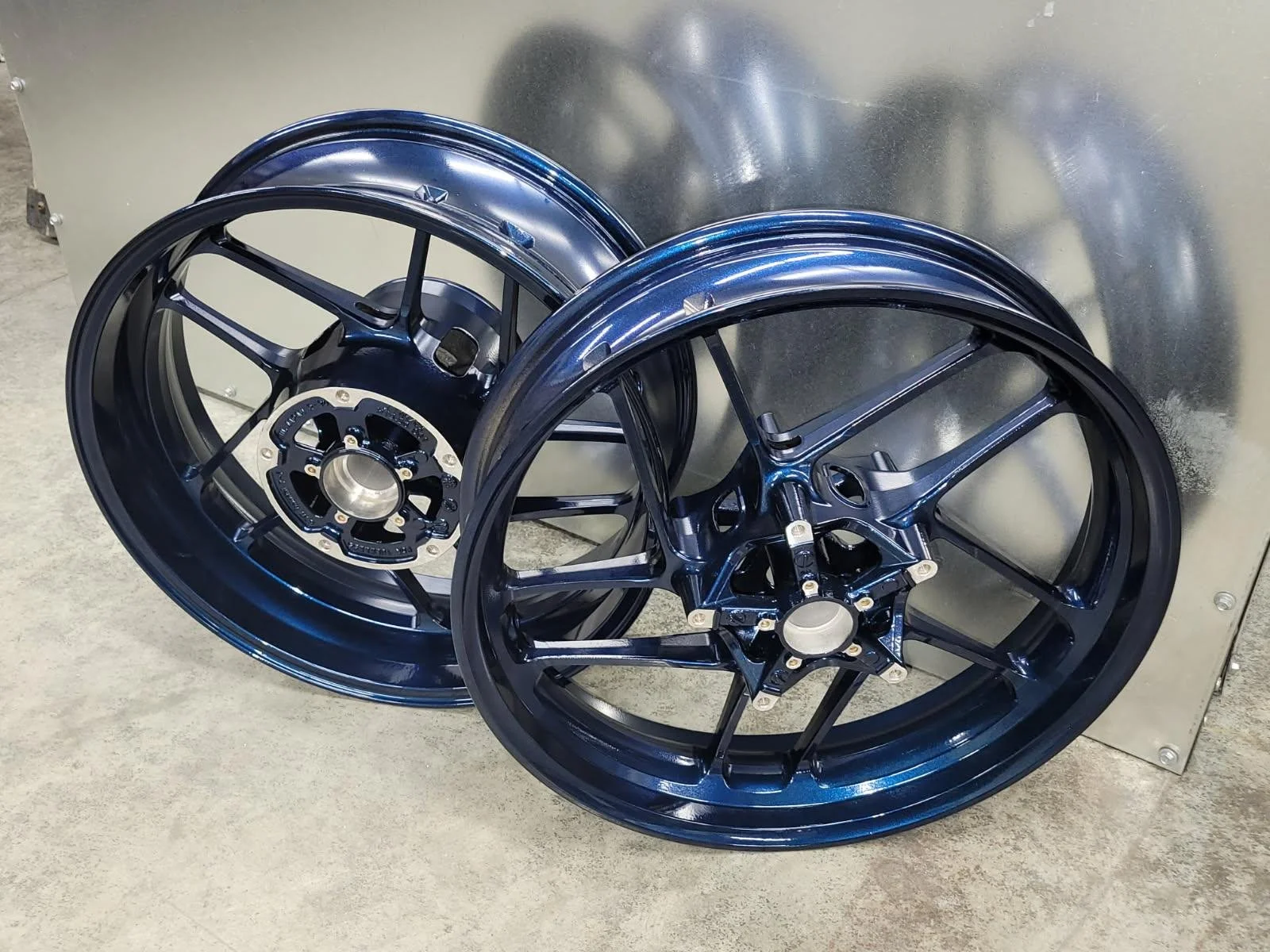 "Motorcycle wheels showcasing a premium dark blue high-gloss powder-coated finish.