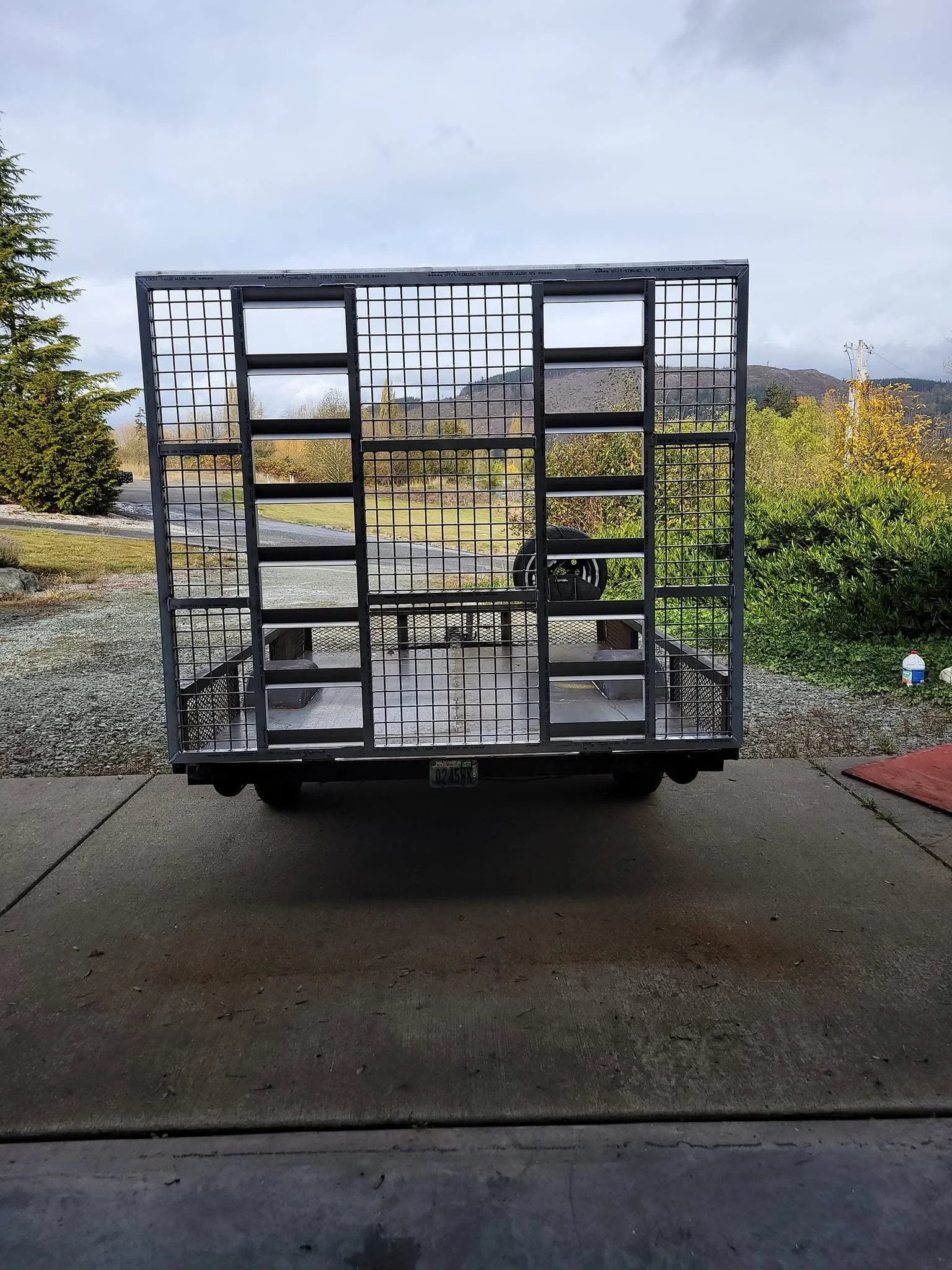 Custom-built metal utility trailer cage and structural rack fabrication for industrial and transport use.
