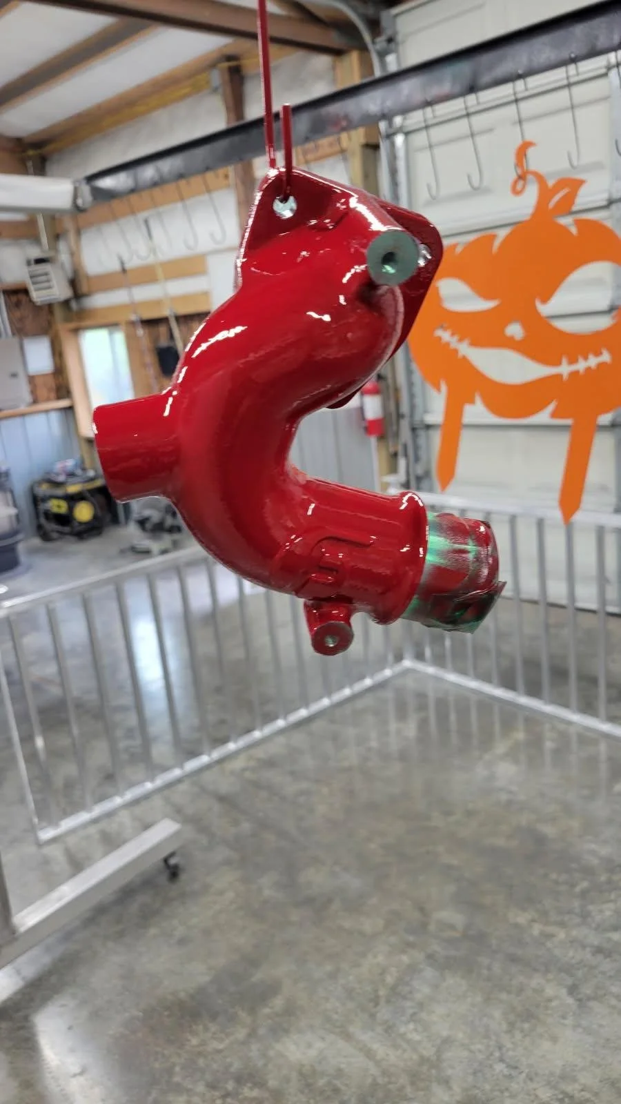 Custom automotive part featuring a high-gloss, durable red industrial powder-coated finish.