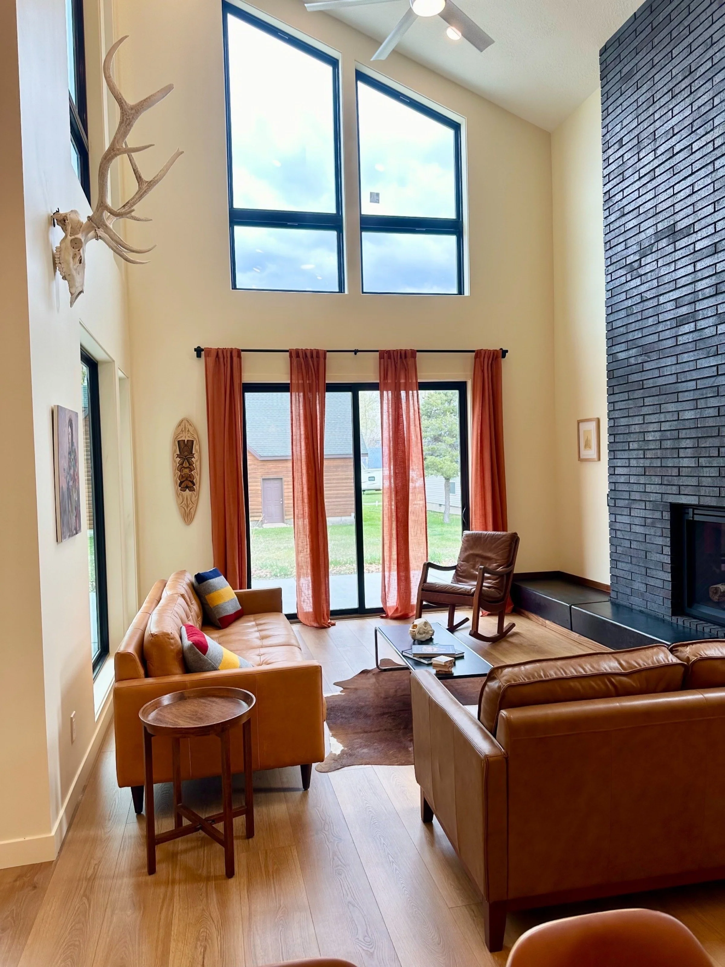 blackwood-residence-modern-living-room-black-brick-fireplace.jpeg
