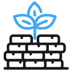 A small plant growing from a pile of black bricks