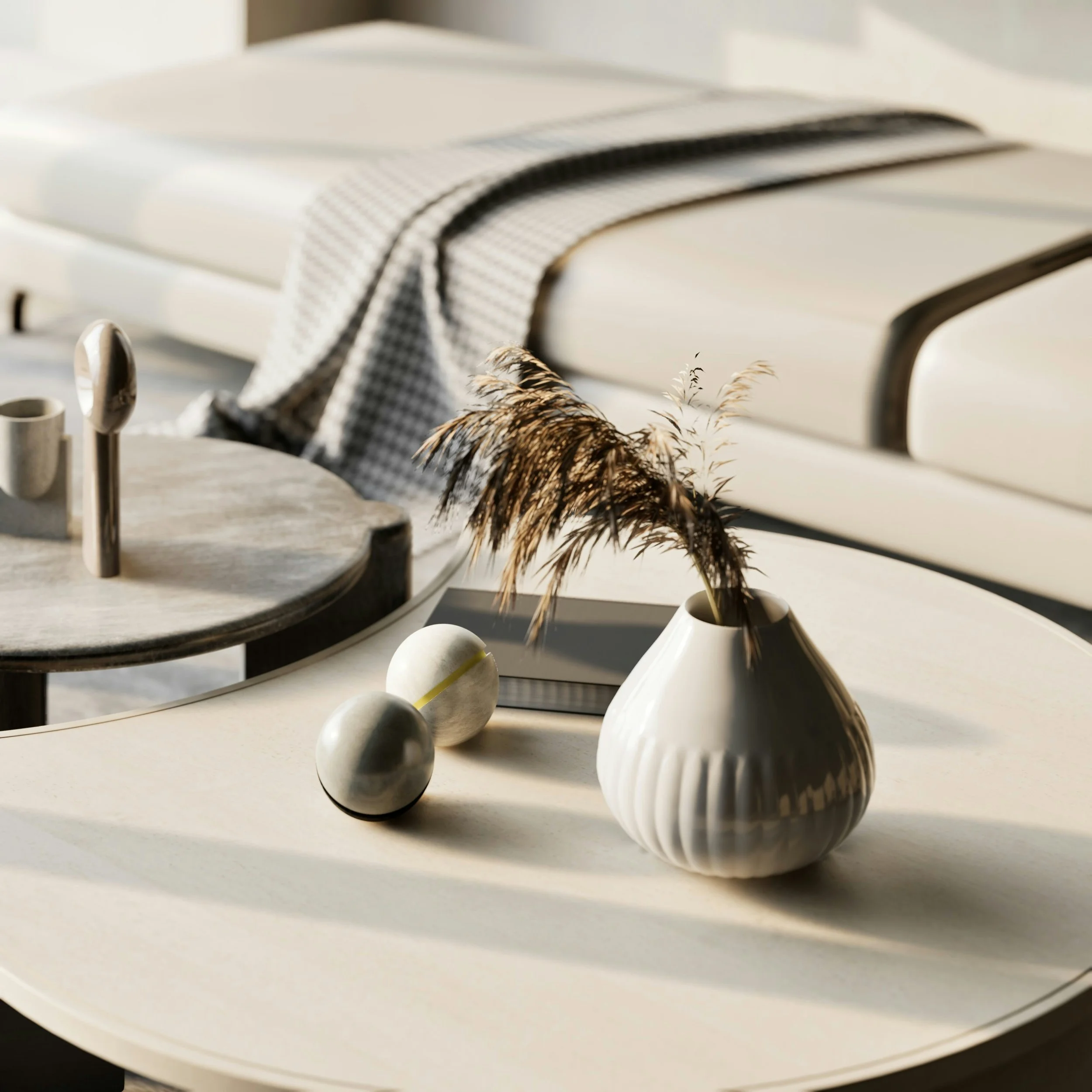 Close-up of books or notebooks with striped and plain covers on a white surface, with dried grass in the foreground.