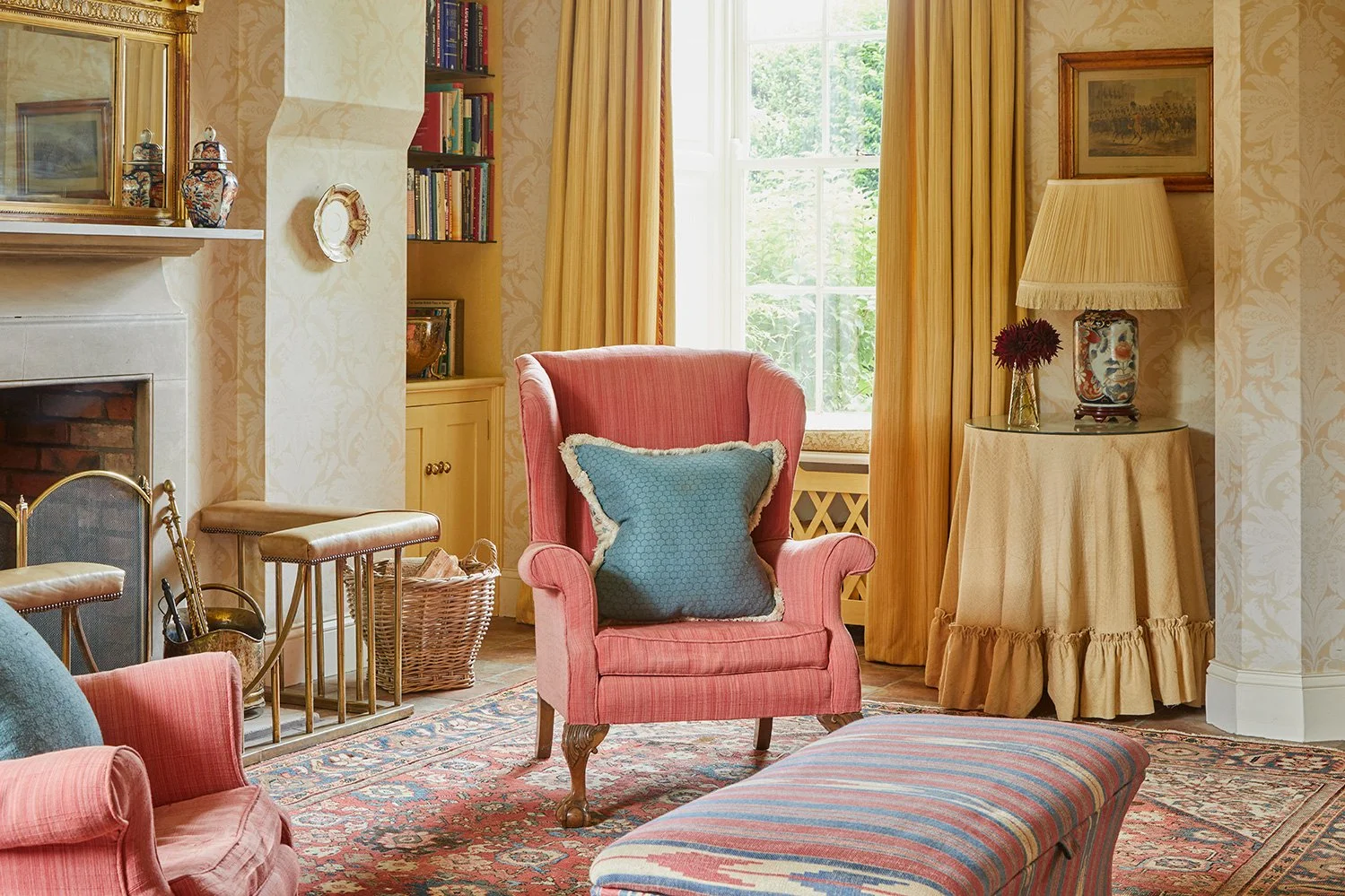 The cosy sitting area with an open fire in the entrance hall at Meadow House