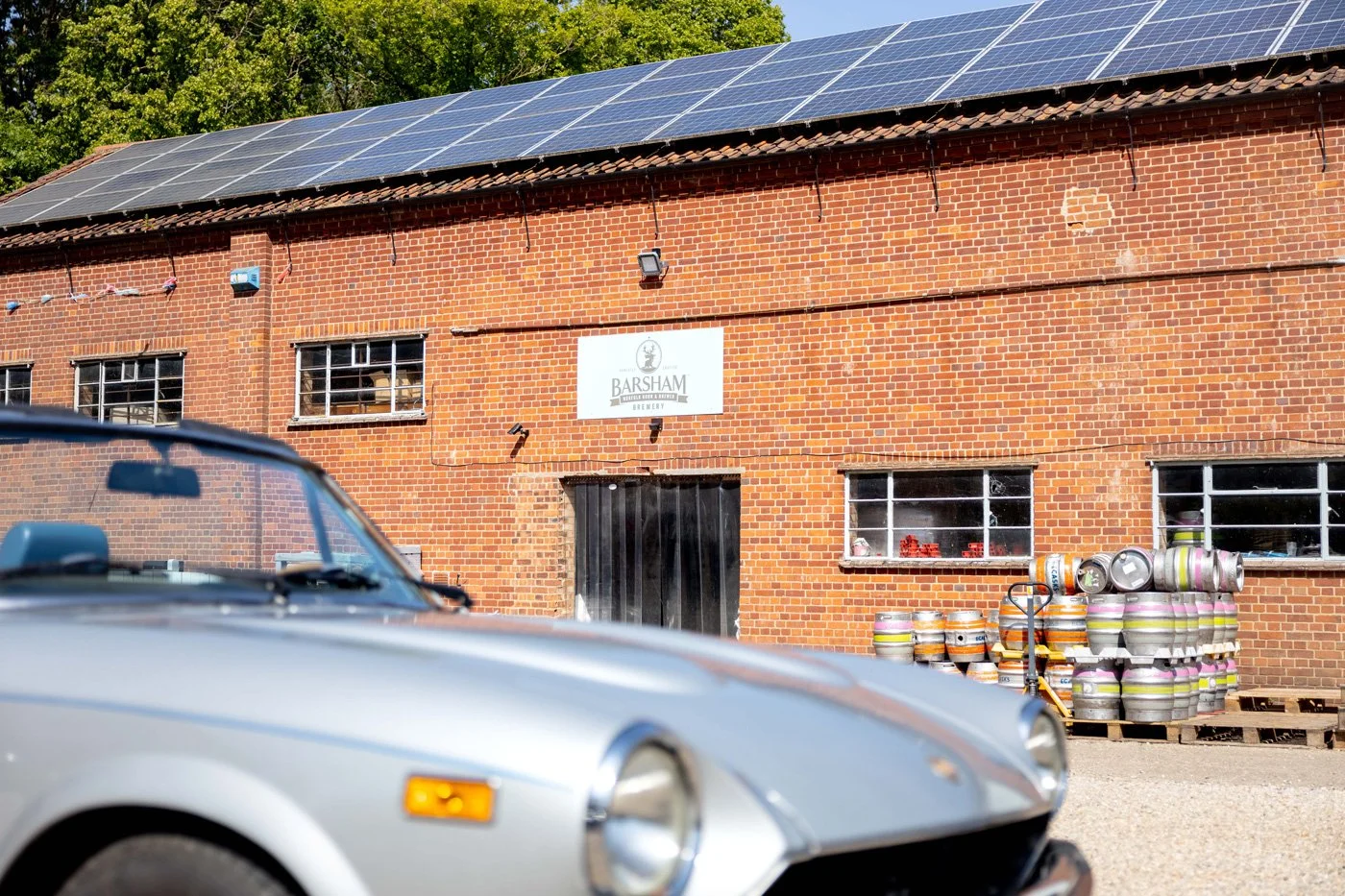 A vintage Porsche parked outside Barsham Brewery