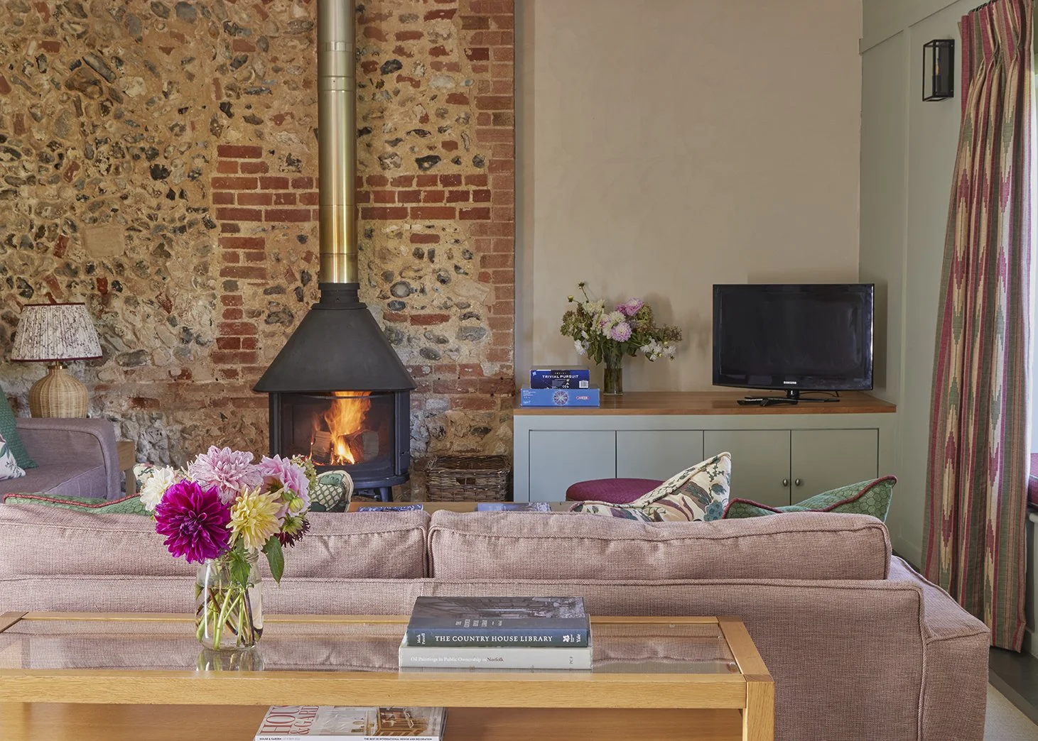 The cosy open plan living area in Little Barsham with wood burner