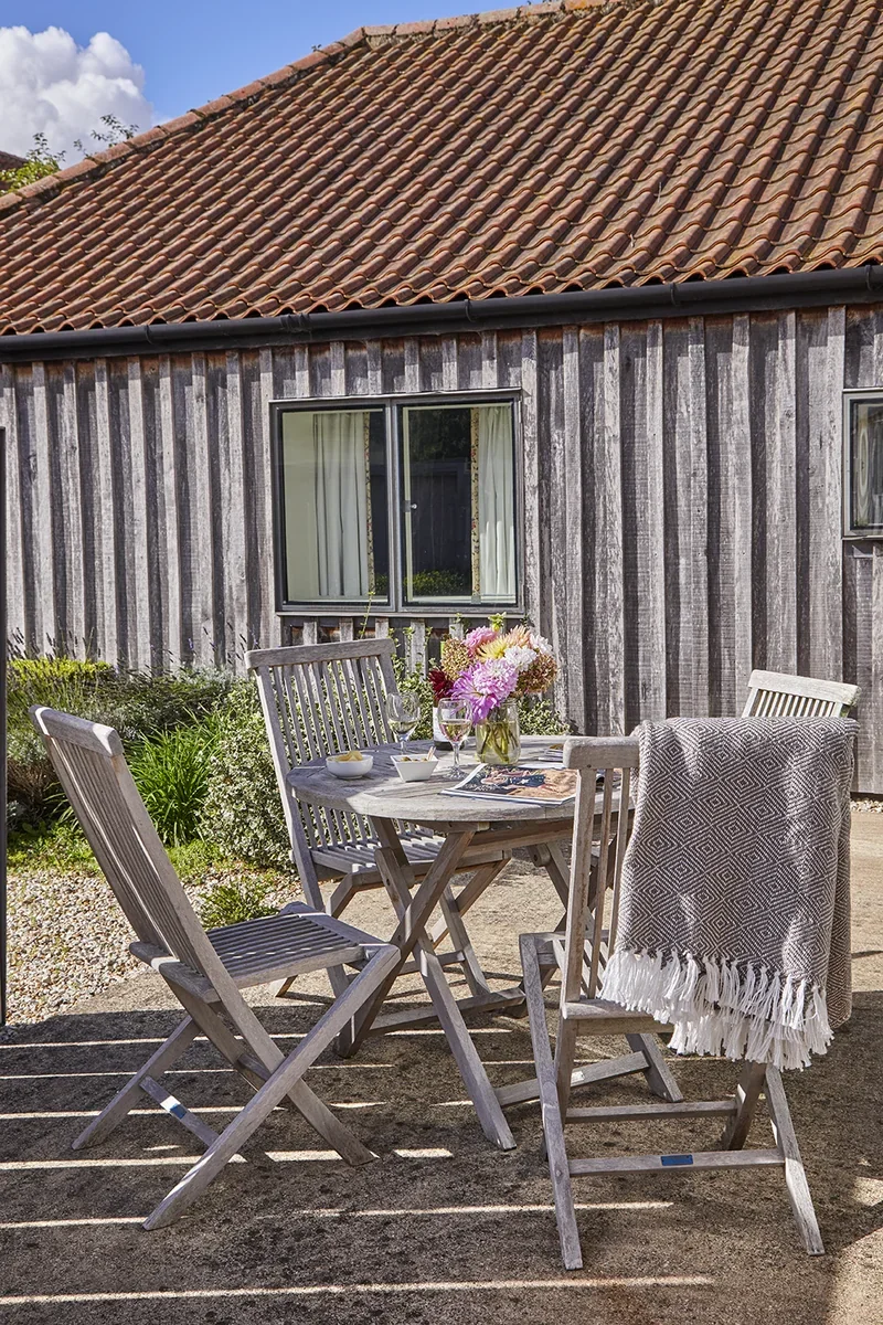 The sunny courtyard garden at Little Barsham with a private seating area