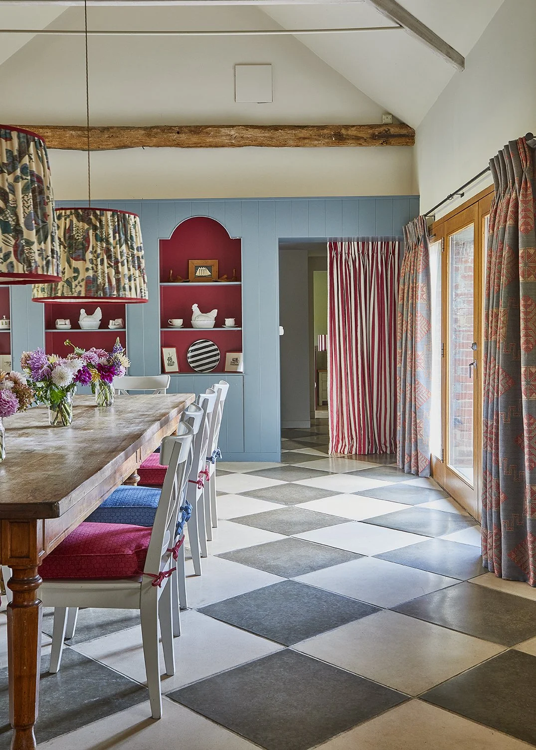 The spectacular dining room with statement shelves and pendant lighting with doors out onto a private courtyard garden