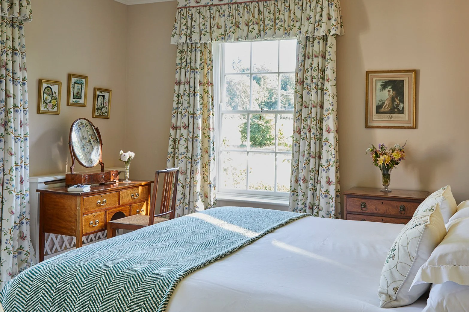 A light double bedroom with views over parkland in Meadow House