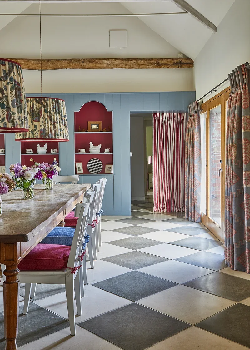 The spectacular dining room with statement shelves and pendant lighting with doors out onto a private courtyard garden