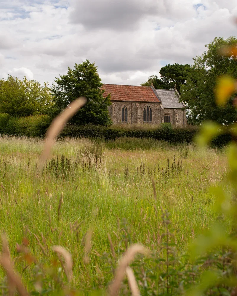 The view from Greys Court over the meadow to the Medieval church