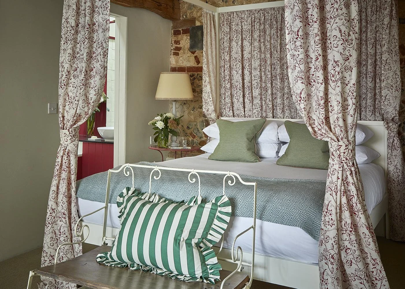The en-suite Master Bedroom in Greys Court with sumptuous fabrics by Flora Soames
